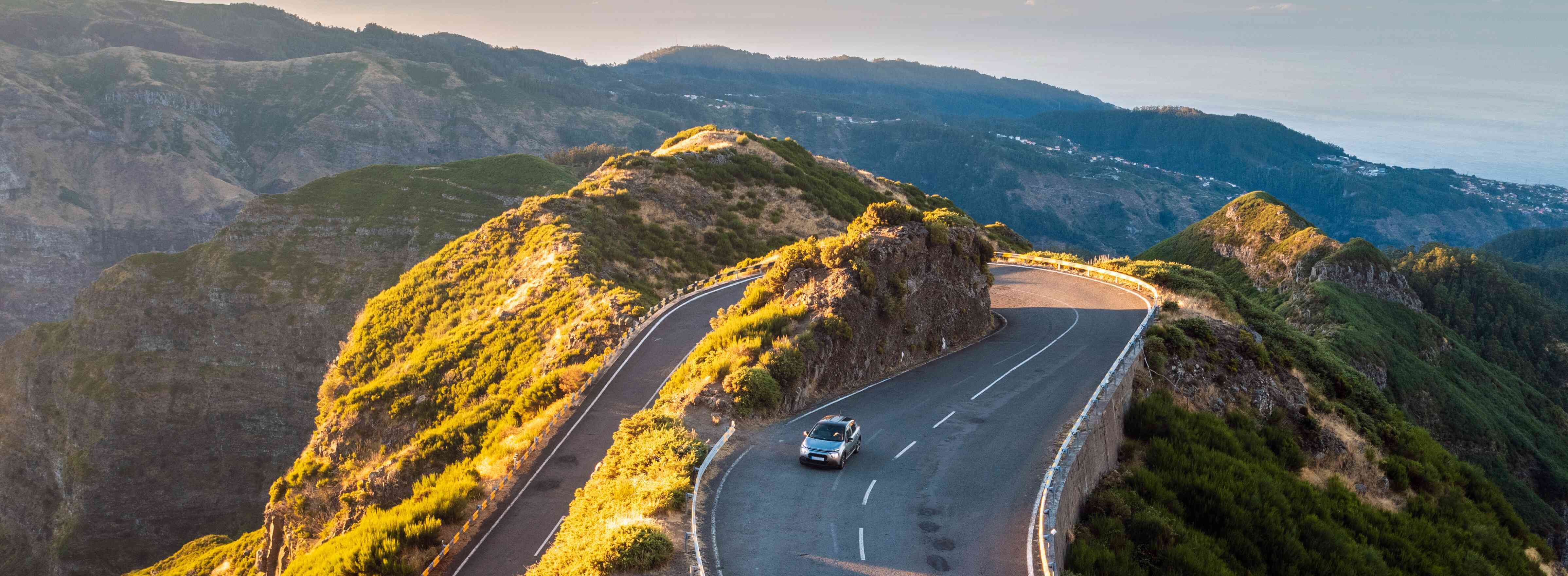 Car driving over a mountain