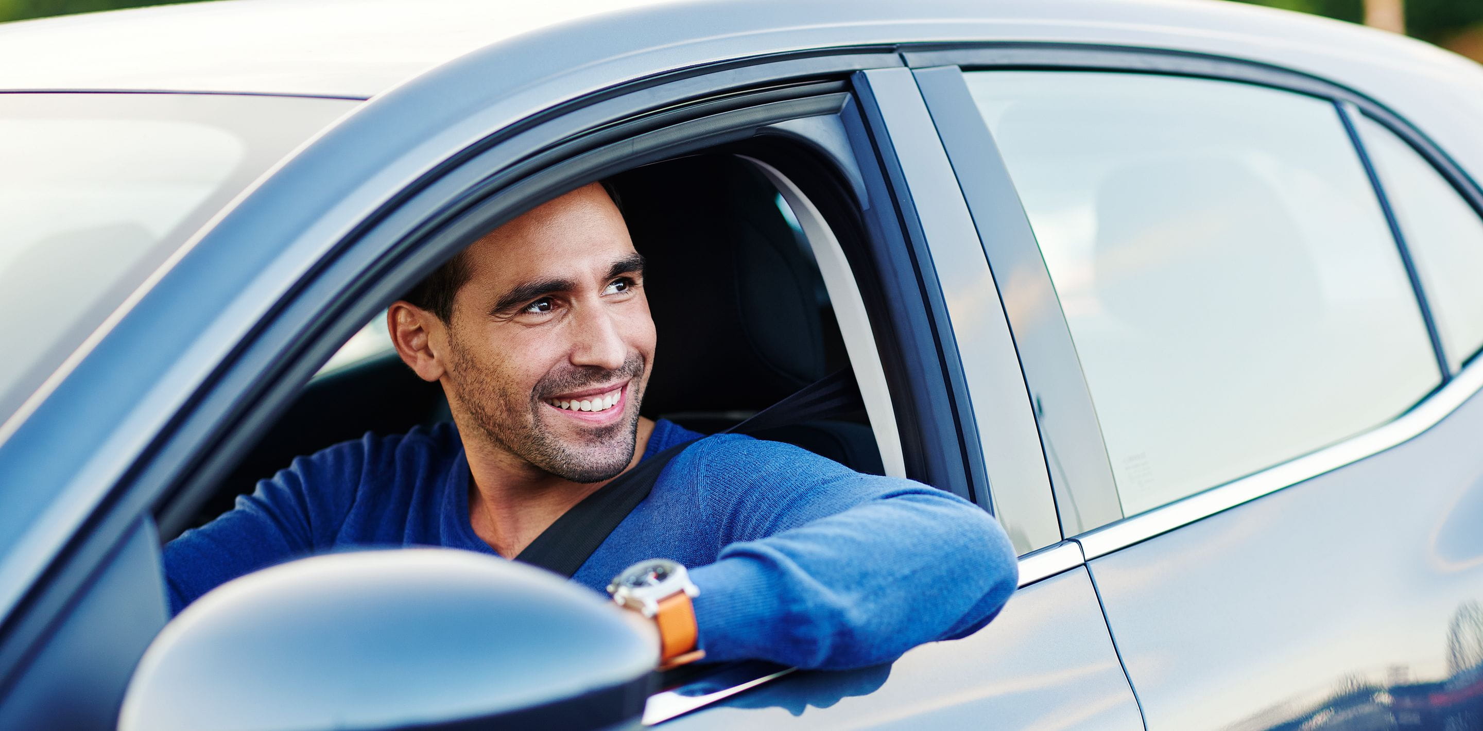 man in a blue car